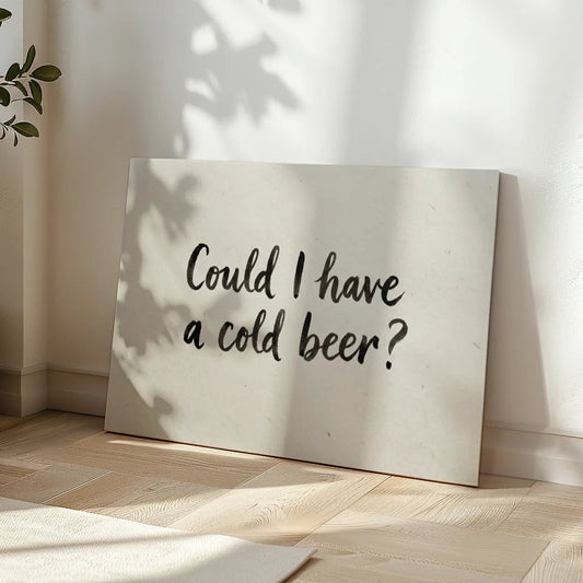 Minimalist canvas wall art with centered black text reading 'Could I have a cold beer?' on a neutral beige backdrop