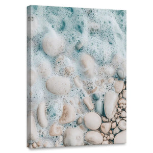 Aerial shoreline canvas wall art for bedroom featuring foamy turquoise waves over smooth pebbles