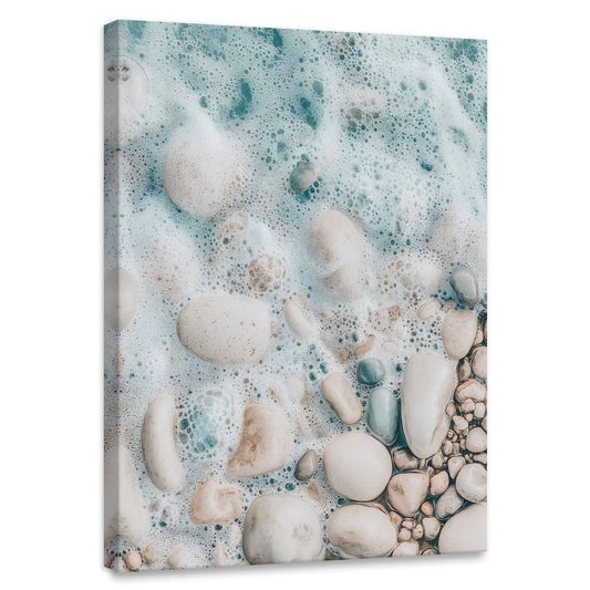 Aerial shoreline canvas wall art for bedroom featuring foamy turquoise waves over smooth pebbles