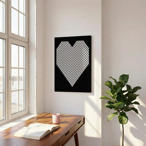 Minimalist canvas wall decor with a symmetrical heart shape filled with evenly spaced black dots against a black backdrop