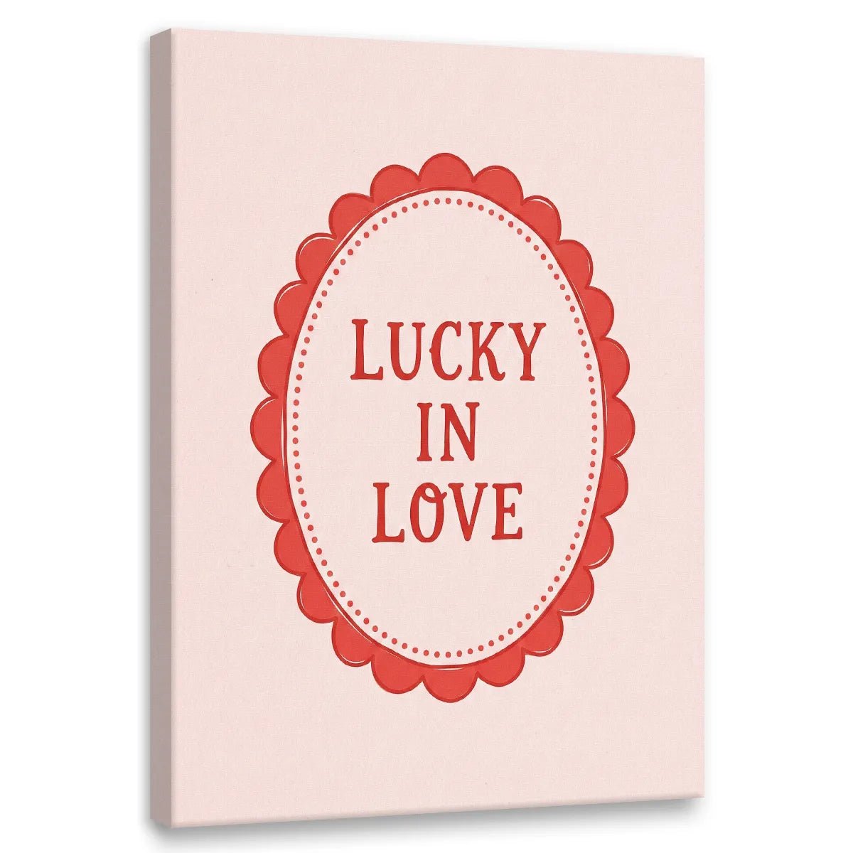 Minimalist canvas wall art featuring red 'LUCKY IN LOVE' text inside a scalloped oval frame on a light pink background