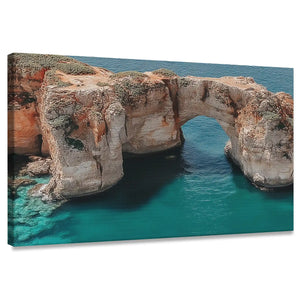 Modern coastal cliff canvas wall art for living room featuring turquoise waters and rocky arch