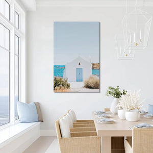 Sunlit coastal chapel canvas print with ocean view, perfect for modern minimalist living space