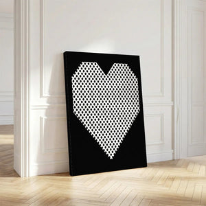 Vertical canvas art with a centered heart made of black polka dots on white, set against a solid black background