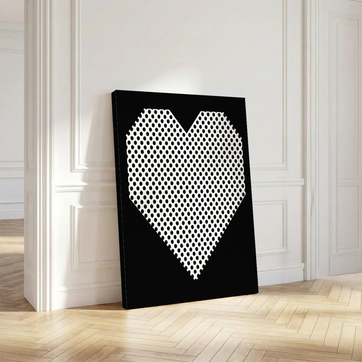 Vertical canvas art with a centered heart made of black polka dots on white, set against a solid black background