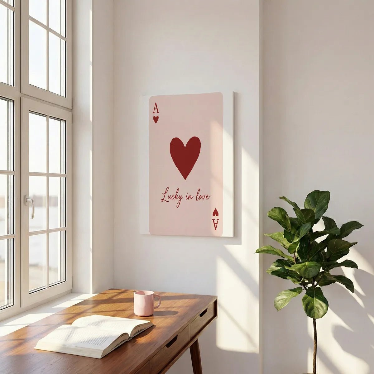 Bold canvas wall art with a centered heart and stylized A above romantic cursive text on a light pink backdrop.
