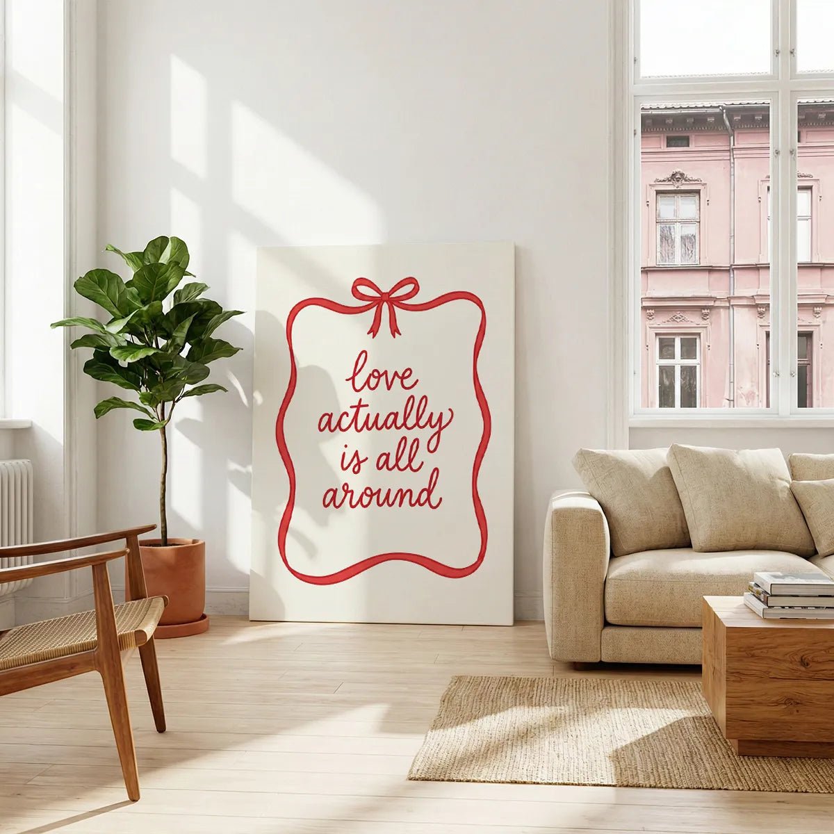 Canvas artwork featuring flat rendering of red ribbon border and romantic quote in flowing hand-lettered style