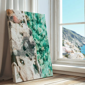 Rocky shoreline with emerald water captured in a contemporary canvas print with abstract style