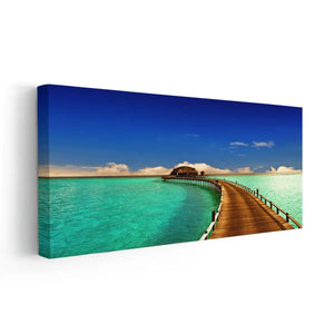  Large beach wall art featuring a stunning wooden boardwalk leading to an ocean bungalow in the Maldives.