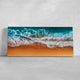 Canvas ocean artwork featuring foamy waves and golden sand.