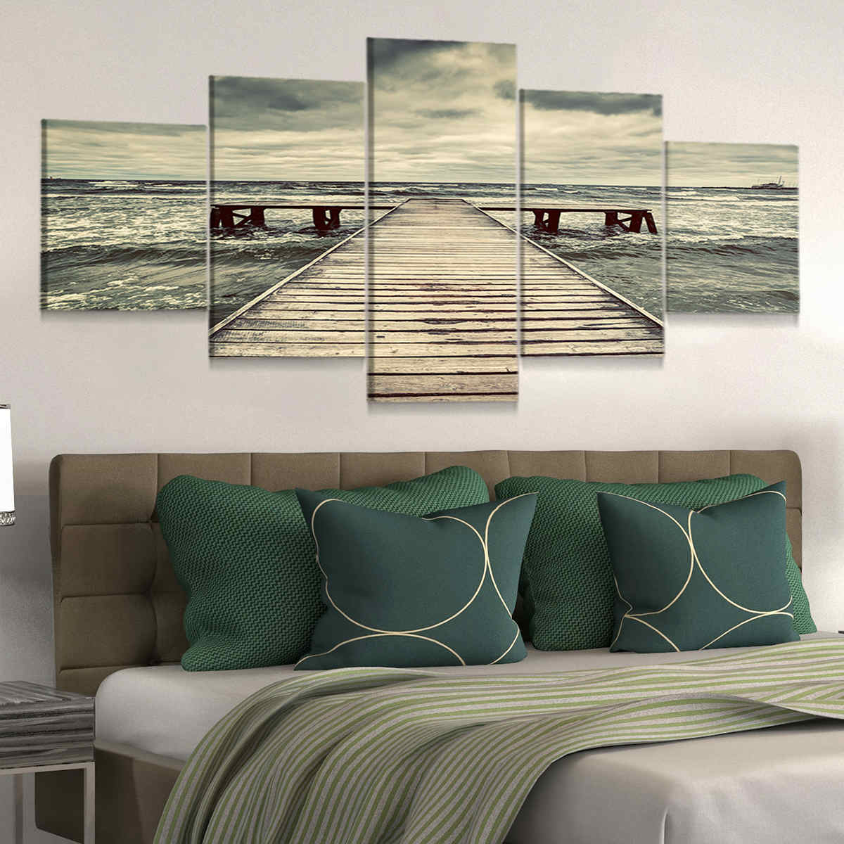 Coastal farmhouse wall decor showcasing an old pier under dark, moody clouds.