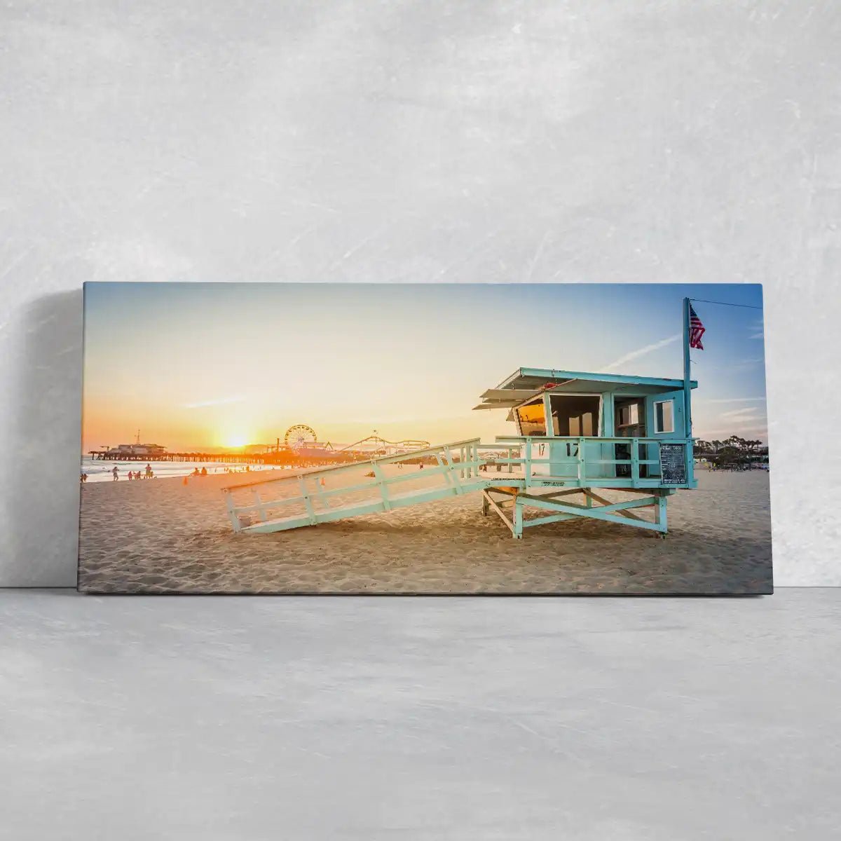 Coastal beach wall decor with a lifeguard tower and warm sunset glow.