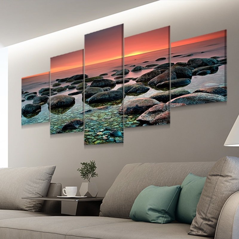 Mystical coastal rocks submerged in water with a dreamy sunset backdrop.