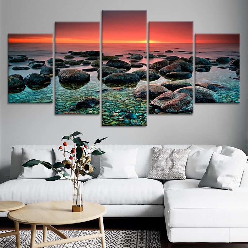 Peaceful ocean stones and glowing sunset in a framed artwork print.