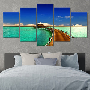 Beach wall art for living room featuring a dreamy Maldives getaway with vibrant ocean hues and a private bungalow.