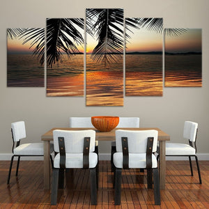 Abstract sunset wall art with palm trees and golden sky.