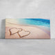  Large wall art beach theme featuring a heartwarming scene of two hearts drawn on the sandy shore.