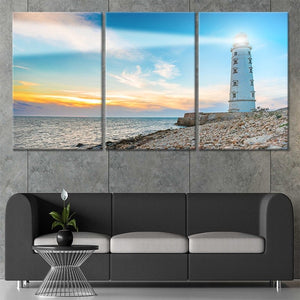 Coastal beach house decor showcasing a lighthouse on rocky shores.