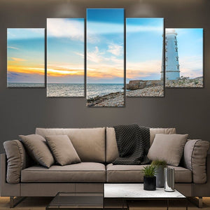 Rustic coastal farmhouse decor with a scenic lighthouse and water.