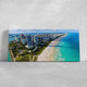 Large canvas print of Miami Beach skyline and turquoise ocean waves.