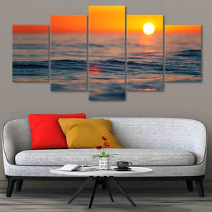 Coastal framed wall art showcasing ocean waves under a glowing sunset.