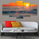 Coastal framed wall art showcasing ocean waves under a glowing sunset.