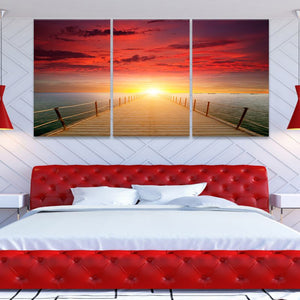 Coastal wall art for bedroom with a vibrant sunset over calm ocean waters.