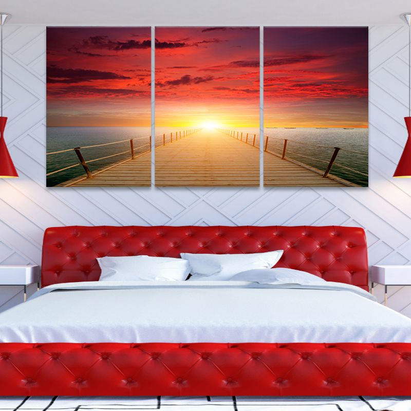 Coastal wall art for bedroom with a vibrant sunset over calm ocean waters.