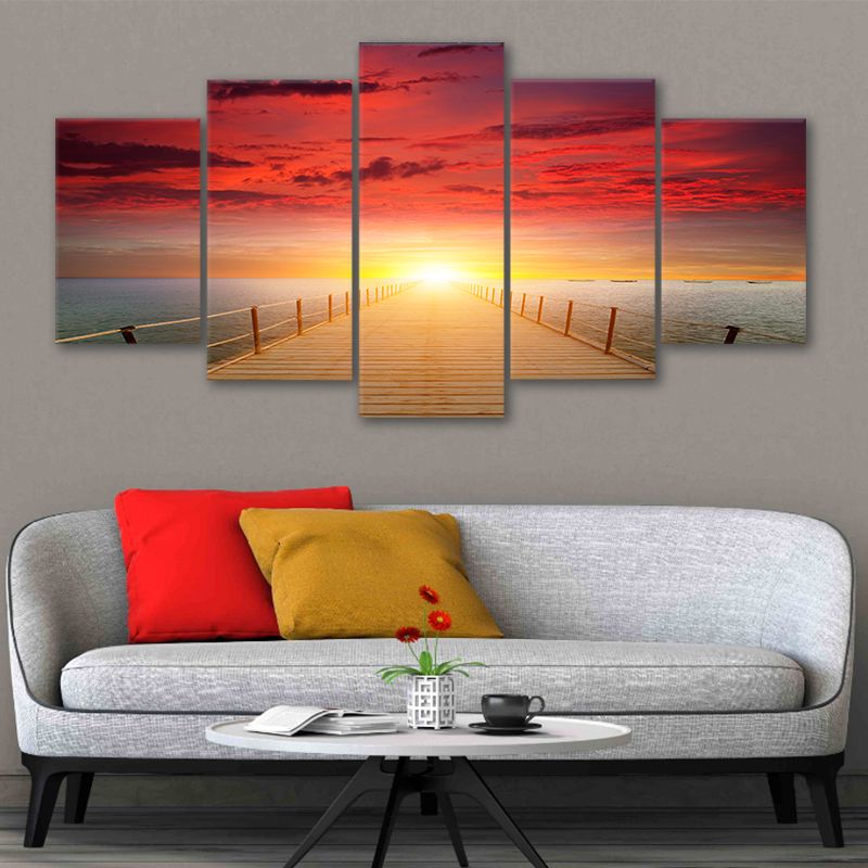 Large wall art beach theme with a brilliant red and orange sunset over the sea.