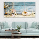 Nautical wall art featuring seashells, starfish, and a weathered wood texture.