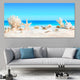 Tropical ocean wall art illustrating ocean treasures resting on smooth white sand, a serene beach scene