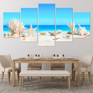 Stunning coastal farmhouse wall art capturing beach elements like coral and shells under a bright sky.