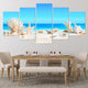 Stunning coastal farmhouse wall art capturing beach elements like coral and shells under a bright sky.